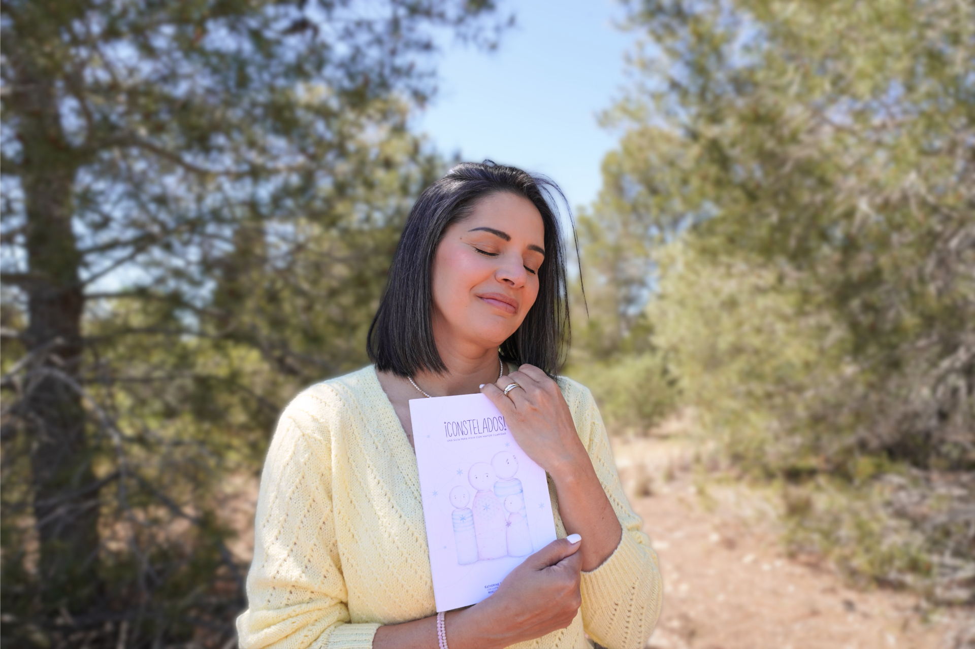 Katherine Simosa en la naturaleza con su libro Constelados